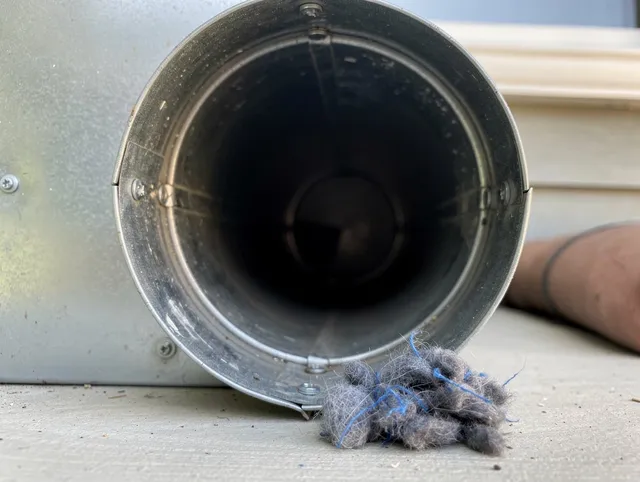 Berea Dryer Vent Cleaning technician using specialized equipment to clear severe dryer vent blockage in Berea